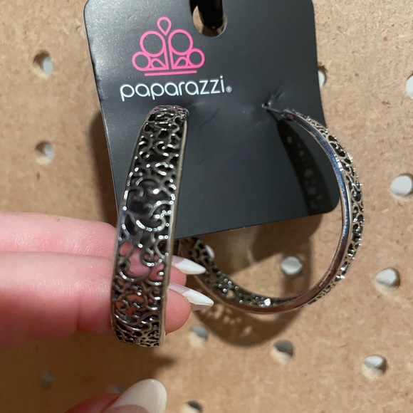 Medium to large size hoops in silver scrollwork with post backs.